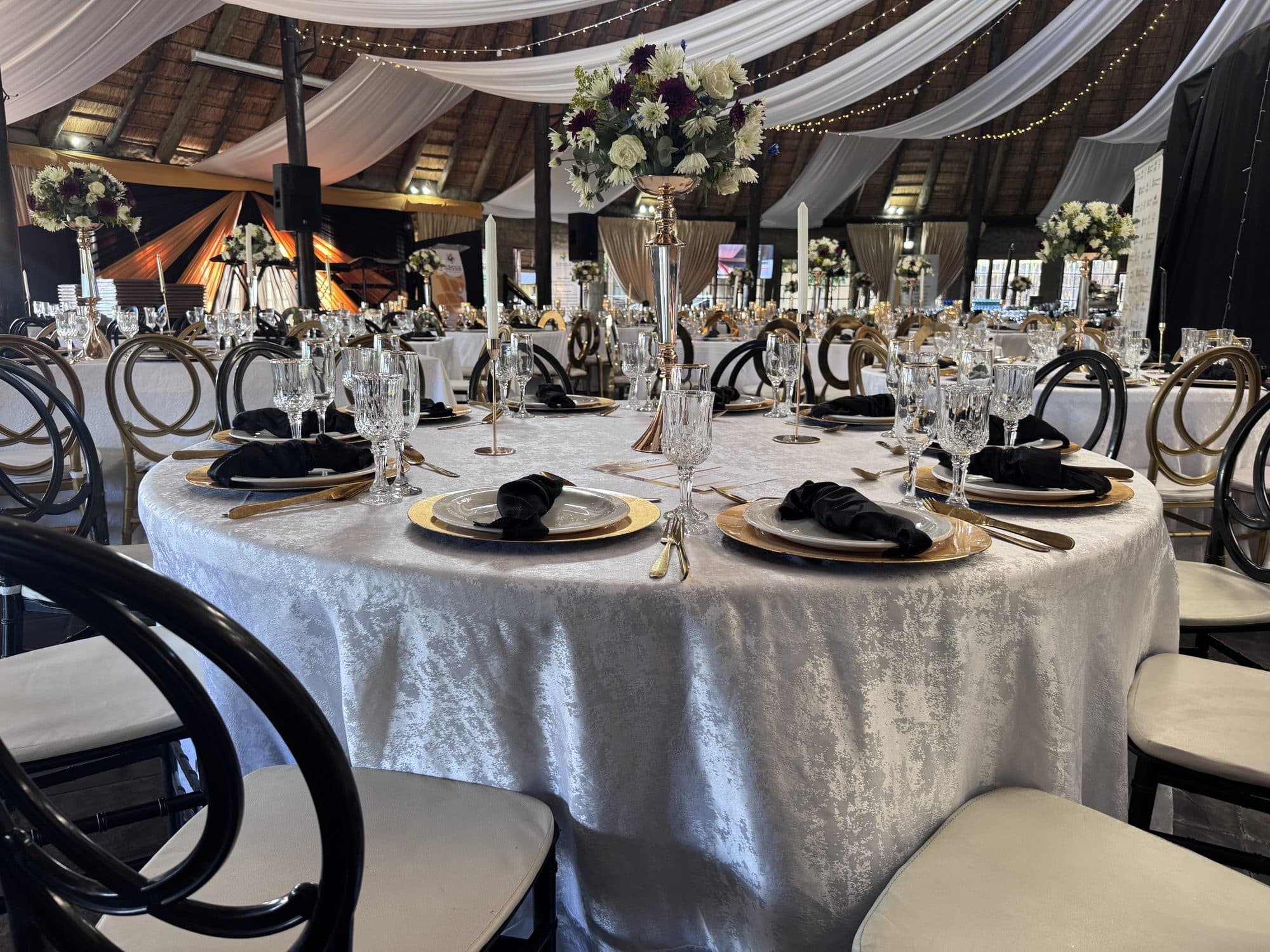 Black, white and gold table styling with floral centrepieces
