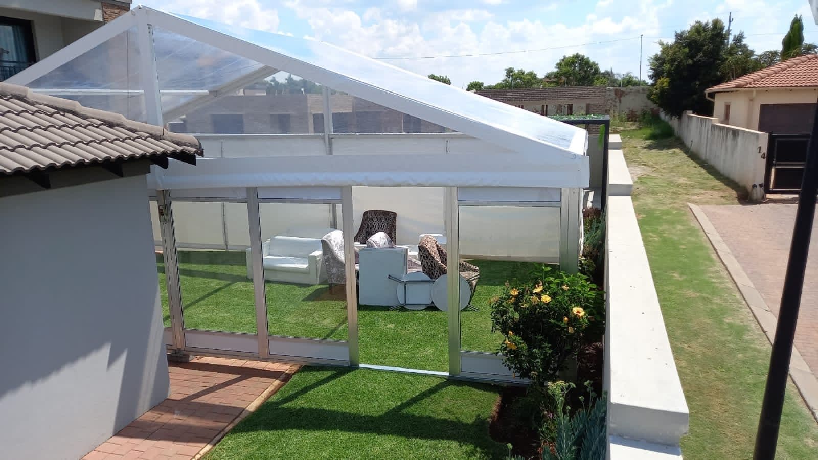Glass-roof marquee installed over a residential garden