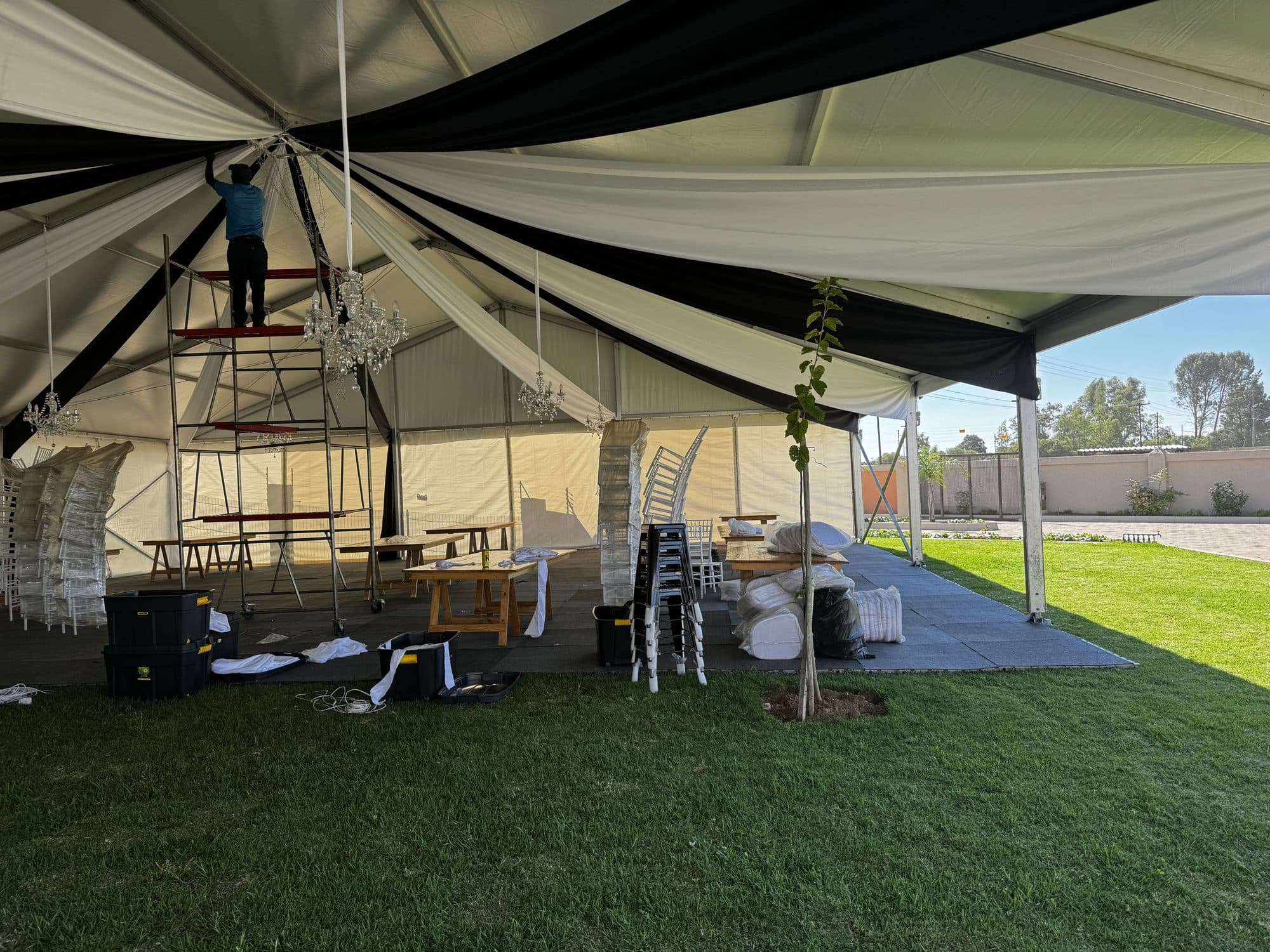 Black and white striped marquee interior during build